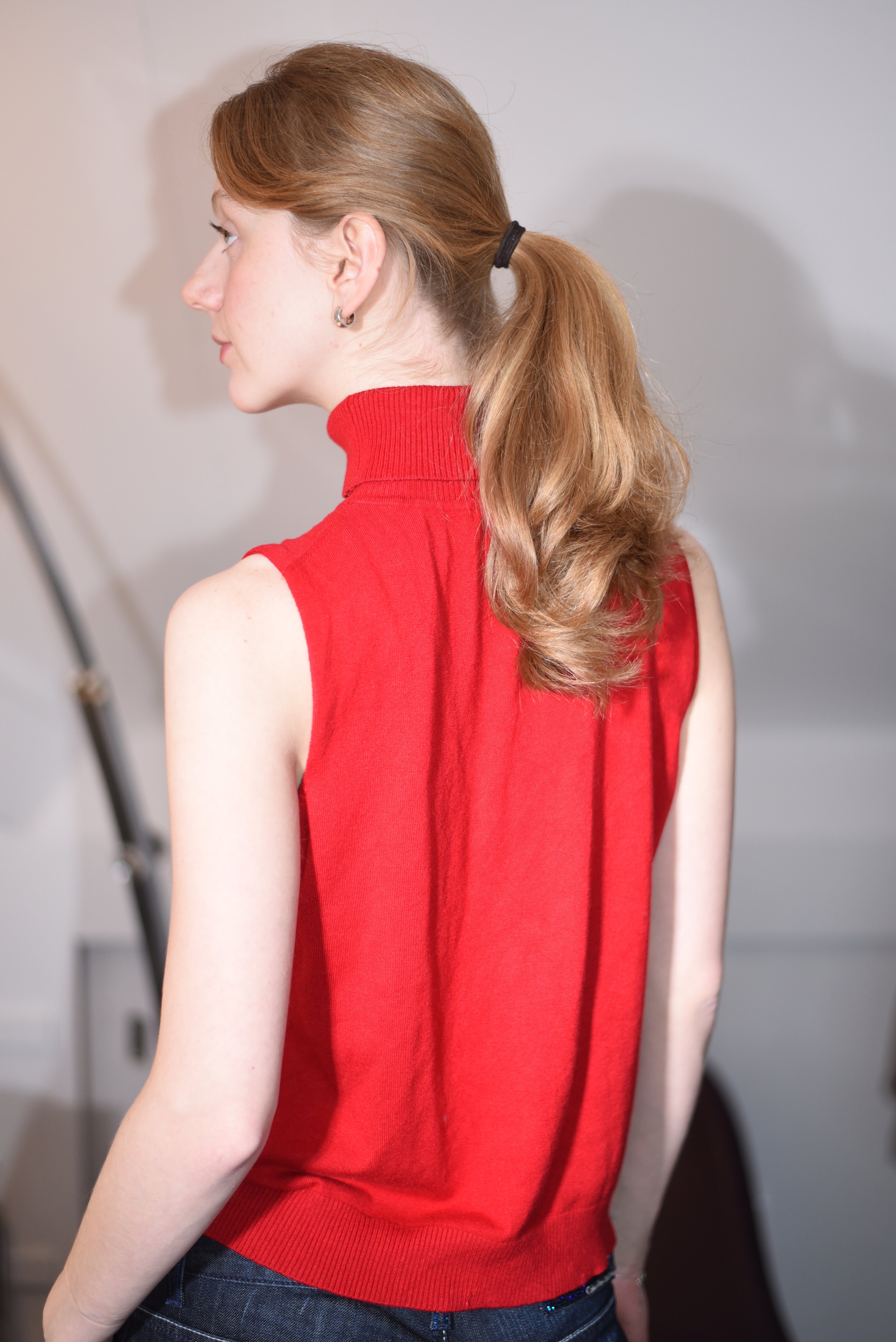 Red sleeveless turtleneck top